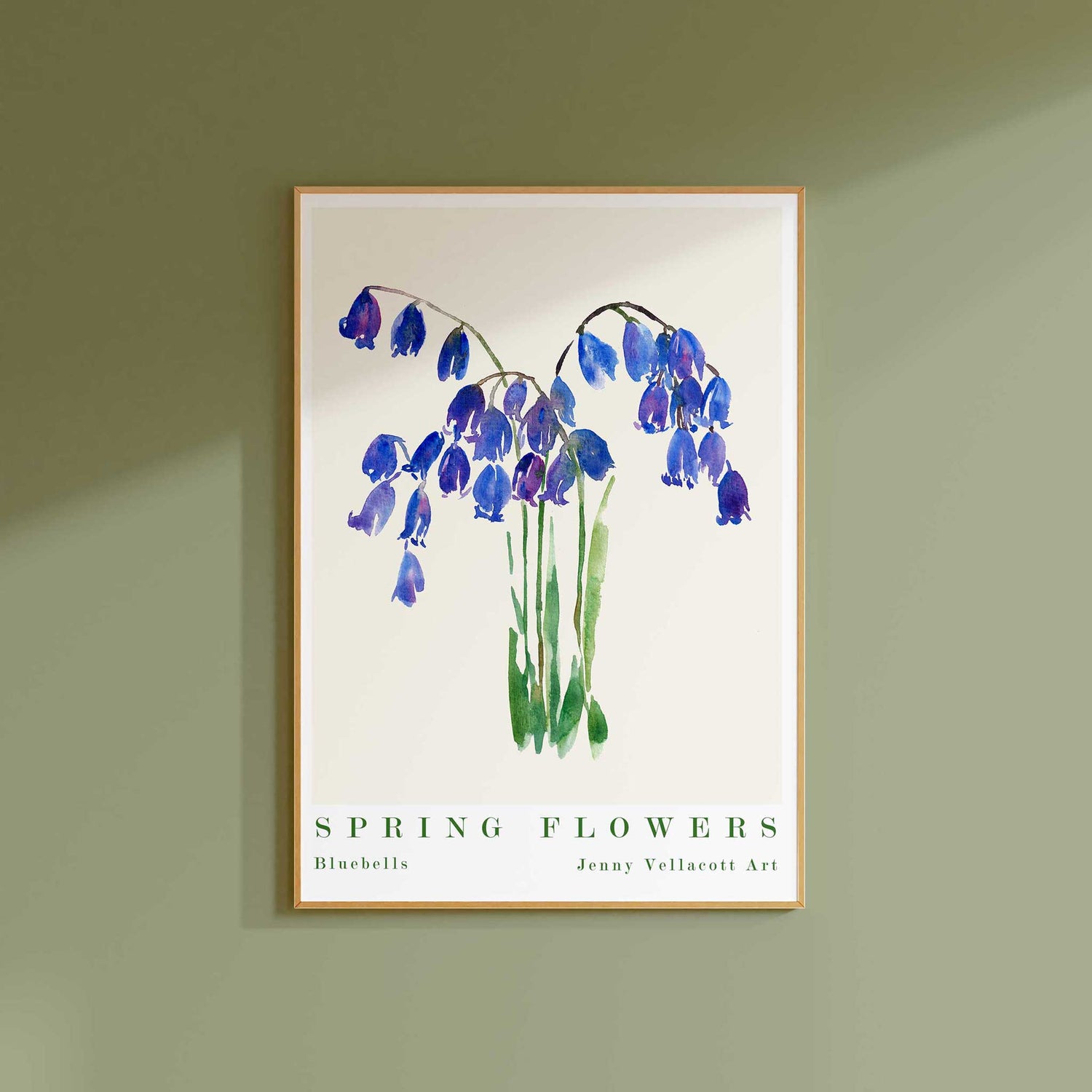 Framed print of watercolour bluebells on a green wall