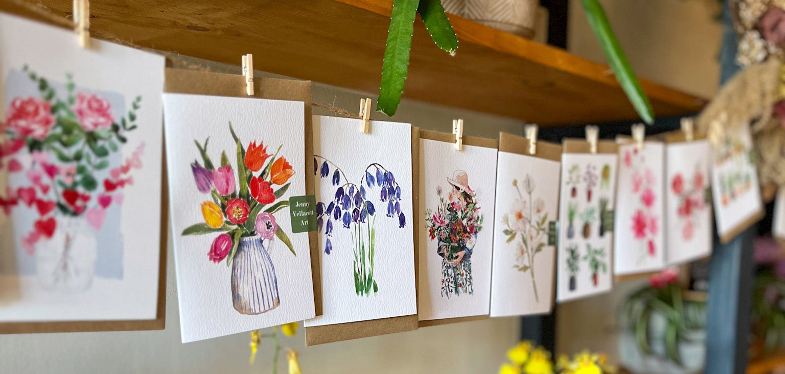 Greeting cards pegged along a string hanging in a florist